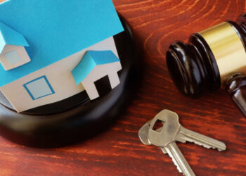 Real Estate Law concept.  Model of house and a gavel.