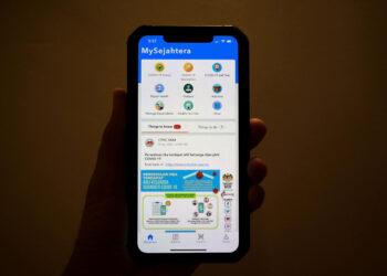 A photo illustration shows the smartphone application "MySejahtera", implemented by the Malaysian government to aid contact tracing efforts in an attempt to curb the spread of the Covid-19 coronavirus, in George Town on Malaysias island of Penang on September 8, 2021. (Photo by Mohd RASFAN / AFP) (Photo by MOHD RASFAN/AFP via Getty Images)