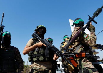 Palestinian fighters from the armed wing of Hamas take part in a military parade to mark the anniversary of the 2014 war with Israel, near the border in the central Gaza Strip, July 19, 2023. REUTERS/Ibraheem Abu Mustafa