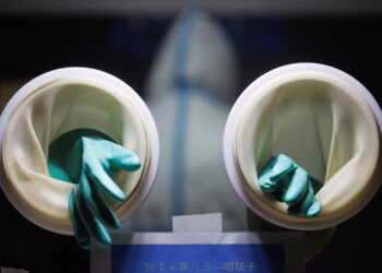 Rubber gloves used to administer throat swab tests are seen at a street booth as the coronavirus disease (COVID-19) pandemic continues in Beijing, China, January 17, 2022. REUTERS/Thomas Peter