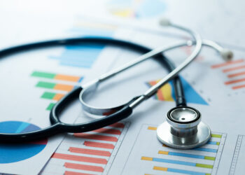 medical statistics and graphic charts with stethoscope