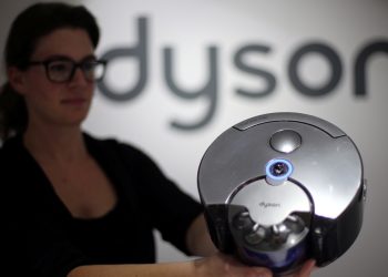 FILE PHOTO: A Dyson employee shows a Dyson 360 Eye robot vacuum cleaner during the IFA Electronics show in Berlin September 4, 2014. REUTERS/Hannibal Hanschke/File Photo