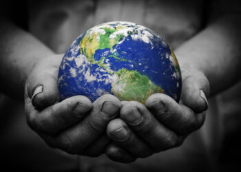 Man holding an earth globe in his hands. Earth image provided by NASA.