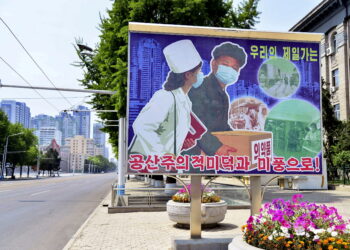 FILE PHOTO: A sign depicting a scene of medical products transportation is displayed at the empty street, amid growing fears over the spread of coronavirus disease (COVID-19), in Pyongyang, North Korea, in this photo released by Kyodo on May 23, 2022. Kyodo via REUTERS