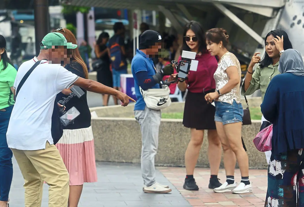 Photo touts in KLCC