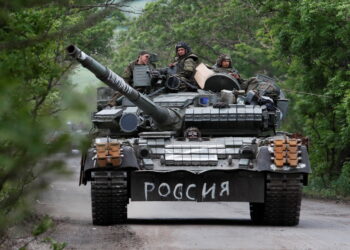 Service members of pro-Russian troops drive a tank during Ukraine-Russia conflict in the Donetsk Region, Ukraine May 22, 2022. The writing on the tank reads: "Russia". REUTERS/Alexander Ermochenko