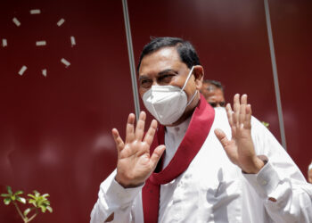 FILE PHOTO: Basil Rajapaksa, one of the brothers of Sri Lanka's president Gotabaya Rajapaksa, gestures as he leaves after he announced that he had resigned from parliament, amid the country's economic crisis, in Colombo, Sri Lanka, June 9, 2022. REUTERS/Dinuka Liyanawatte