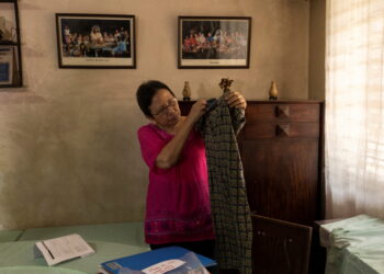Cristina Bawagan, 67, shows the dress she wore when she was arrested, tortured and sexually abused by soldiers during the late Philippines' dictator Ferdinand Marcos's brutal era of martial law, in her home at Quezon City, Metro Manila, Philippines, April 22, 2022. Picture taken April 22, 2022.REUTERS/Eloisa Lopez