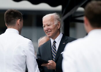 U.S. President Joe Biden gives a diploma to a midshipman during the U.S. Naval Academy graduation and commissioning ceremony in Annapolis, Maryland, U.S., May 27, 2022. REUTERS/Elizabeth Frantz