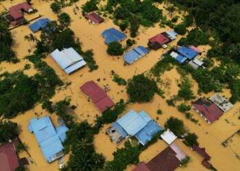 An aerial view shows residential buildings surrounded by flood waters after overnight heavy rain in Karak, Malaysia's Pahang state, on February 19, 2025. (Photo by Mohd RASFAN / AFP) / The erroneous mention[s] appearing in the metadata of this photo by Mohd RASFAN has been modified in AFP systems in the following manner: [Karak, Malaysia] instead of [Karak, Jordan]. Please immediately remove the erroneous mention[s] from all your online services and delete it (them) from your servers. If you have been authorized by AFP to distribute it (them) to third parties, please ensure that the same actions are carried out by them. Failure to promptly comply with these instructions will entail liability on your part for any continued or post notification usage. Therefore we thank you very much for all your attention and prompt action. We are sorry for the inconvenience this notification may cause and remain at your disposal for any further information you may require.