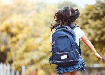 Back to school. Cute asian child girl with backpack running and going to school with fun