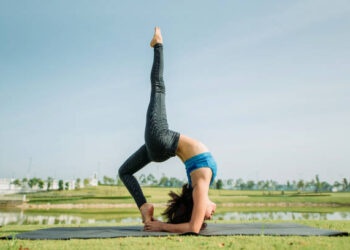 wide shot of women do stretching exercise yoga pose on yoga mat outdoor