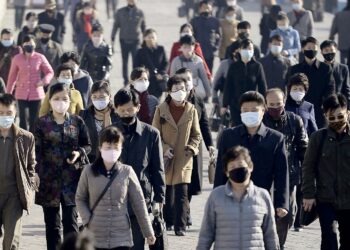 FILE PHOTO: People wearing protective face masks commute amid concerns over the new coronavirus disease (COVID-19) in Pyongyang, North Korea March 30, 2020, in this photo released by Kyodo. Kyodo/via REUTERS/File Photo