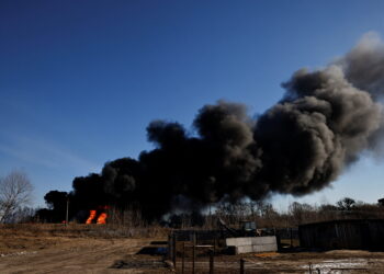 A column of smoke rises from burning fuel tanks that locals said were hit by five rockets at the Vasylkiv Air Base, following Russia's invasion of Ukraine, outside Kyiv, Ukraine, March 12, 2022. REUTERS/Thomas Peter